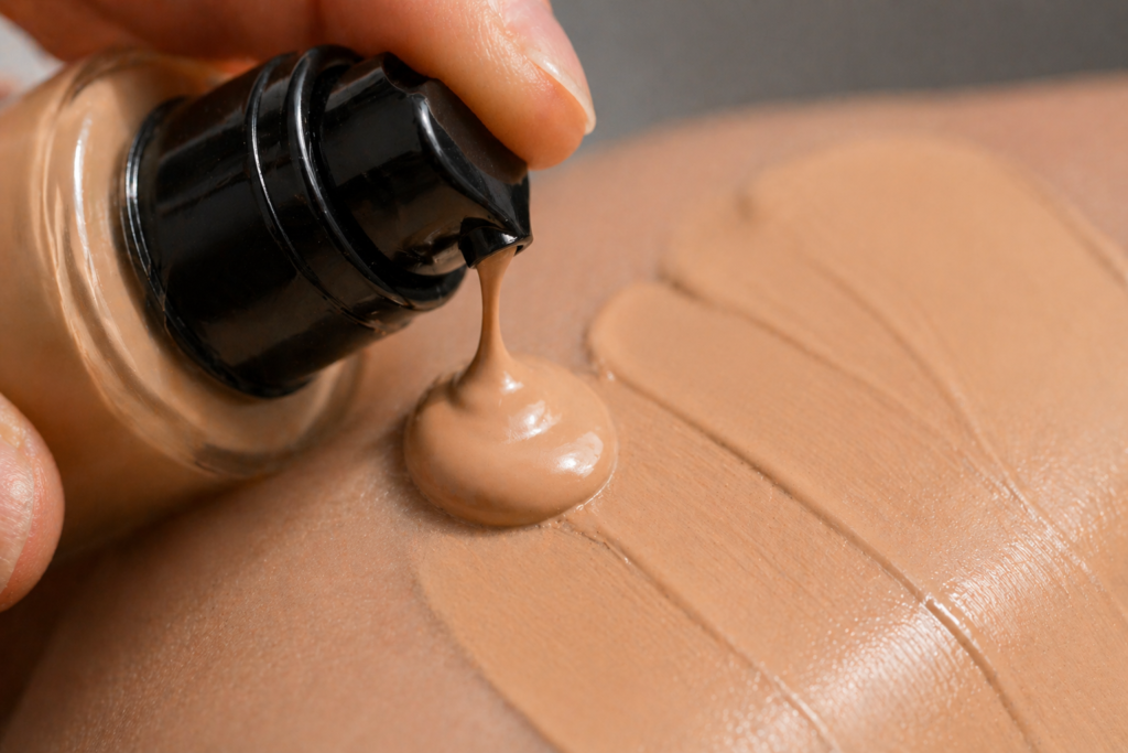 Liquid foundation being dispensed from a pump onto skin showing smooth creamy texture