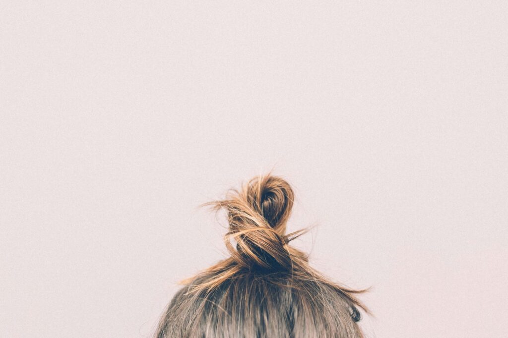 Short new baby hairs growing along a hairline, a sign of hair regrowth