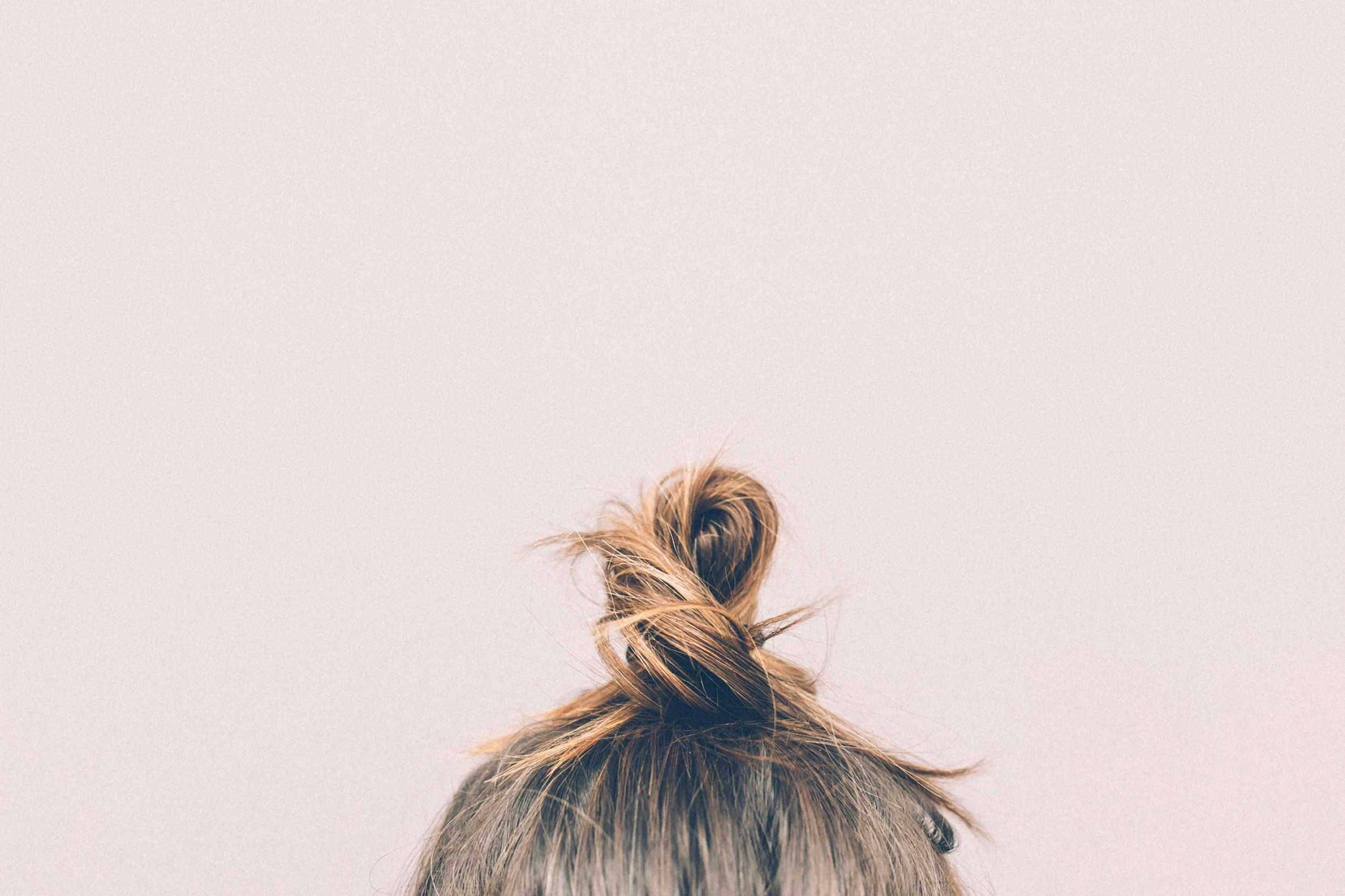 Short new baby hairs growing along a hairline, a sign of hair regrowth